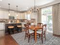 Eat-in kitchen features stainless appliances, granite counters, an island, and access to the patio at 1109 Saratoga Blvd, Indian Trail, NC 28079