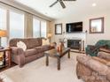 Inviting living room featuring a cozy fireplace, plush seating, and ample natural light at 1109 Saratoga Blvd, Indian Trail, NC 28079