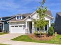Charming single-Gathering home showcasing a well-maintained lawn and attached two-car garage at 1120 Idyllic Ln, Waxhaw, NC 28173