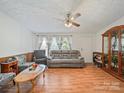 Inviting living room showcasing stylish wood-look floors, neutral wall paint, and a ceiling fan at 130 Benton Rd, Kings Mountain, NC 28086