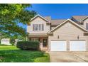 Inviting two-story home with well-maintained lawn, brick accents, and a convenient two-car attached garage at 130 Ridge Bluff Rd, Mooresville, NC 28115