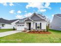 Attractive single-story home with a well-maintained lawn, stone details, and inviting entrance at 1425 Ardmore Dr # 247, Sherrills Ford, NC 28673
