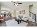 Open concept living room with hardwood floors, staircase, neutral walls, and an inviting atmosphere at 154 King William Dr, Mooresville, NC 28115