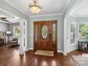 Inviting foyer features a wood front door with decorative glass and wood floors at 165 Cottontail Se Ln, Concord, NC 28025