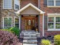 Close-up of the front entrance, featuring a beautiful wooden door and stone porch steps at 165 Cottontail Se Ln, Concord, NC 28025