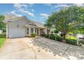 Well-maintained one-story home with manicured lawn, inviting entryway, and an attached single-car garage at 168 Devon Forest Dr, Mooresville, NC 28115