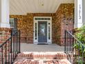 Charming covered front porch with brick columns and iron railings welcomes you to this beautiful home at 17012 Alydar Commons Ln, Charlotte, NC 28278