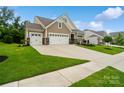 Charming home boasts manicured lawn, stone accents, and a convenient two-car garage, offering a welcoming exterior at 17733 Burnt Hickory Dr, Charlotte, NC 28278