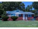 Quaint red brick home featuring a neatly kept lawn and classic architectural elements at 1926 Eastway Dr, Charlotte, NC 28205