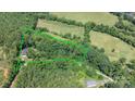 Acreage featuring beautiful trees and greenery outlines the property with a home and outbuilding on site at 200 Vista Pointe Dr, Stony Point, NC 28678