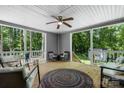 Relaxing covered patio with comfortable seating, ceiling fan, and wooded view at 200 Vista Pointe Dr, Stony Point, NC 28678