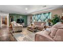 Cozy living room with large window, plush seating, and attractive accent wall at 200 Vista Pointe Dr, Stony Point, NC 28678