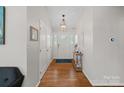 Inviting foyer with hardwood floors, coat closet, and stylish light fixture at 21212 Rio Oro Dr, Cornelius, NC 28031