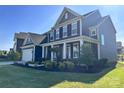 Charming two-story home showcasing professional landscaping and a manicured lawn in a residential neighborhood at 235 Boxelder Rd, Clover, SC 29710