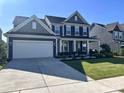 Charming two-story home with manicured lawn, attached garage and covered front porch at 235 Boxelder Rd, Clover, SC 29710