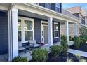 Cozy front porch featuring comfortable seating, decorative plants, and an inviting entrance to the home at 235 Boxelder Rd, Clover, SC 29710