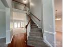 Bright foyer with hardwood floors, carpeted stairs, and open view into living spaces at 2609 Lamp Post Ln, Kannapolis, NC 28081