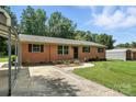 Brick ranch-style house featuring a driveway, carport, and landscaped yard at 2705 Lowell Bethesda Rd, Gastonia, NC 28056