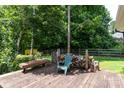 Relaxing backyard deck with a wooded view, seating, and a rustic woodpile at 2825 Edwin Jones Dr, Charlotte, NC 28269