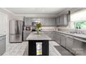 Spacious kitchen with gray cabinets, granite countertops, stainless steel appliances, and a center island at 3109 Buckleigh Dr, Charlotte, NC 28215