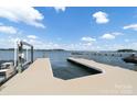 Personal boat dock featuring modern lift system with serene lake views at 3394 Governors Island Dr, Denver, NC 28037