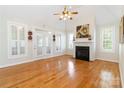 Spacious living room with hardwood floors, fireplace, and bright windows at 3624 Ramsey Rd, Sharon, SC 29742