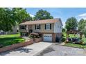 Attractive home with a well-kept lawn, a paved driveway, and an inviting outdoor gathering spot at 3651 16Th Ne St, Hickory, NC 28601