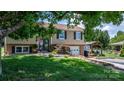 Beautifully landscaped front yard featuring lush greenery, a well-maintained lawn, and a welcoming entrance at 3651 16Th Ne St, Hickory, NC 28601