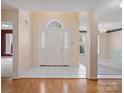 Bright foyer featuring tile flooring, a white door, and views into other rooms at 3720 Winterberry Nw Ct, Concord, NC 28027
