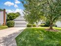 Inviting one-story home with a spacious driveway and well-maintained front yard and mature trees at 3720 Winterberry Nw Ct, Concord, NC 28027