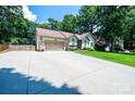 Single-story home with a two-car garage, wide driveway and beautiful landscaping at 3889 Mattingly Dr, Hickory, NC 28602