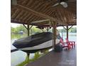 Covered boat lift with modern boat, with a lakeside view perfect for waterfront activities at 4485 River Oaks Rd, Lake Wylie, SC 29710