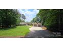 Charming ranch home featuring well-manicured lawn and two-car garage, with stone and siding accents at 4485 River Oaks Rd, Lake Wylie, SC 29710