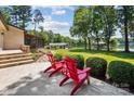 Spacious patio with outdoor seating overlooking a lush yard and lake at 4485 River Oaks Rd, Lake Wylie, SC 29710