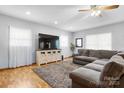 Spacious living room featuring a large gray sectional couch, entertainment center, and ample natural light at 50 Isenhour Park Rd, Taylorsville, NC 28681