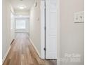 Hallway featuring wood floors, white trim and plenty of natural light at 5375 Eneida Sue Dr, Charlotte, NC 28214