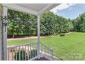 Covered porch offering scenic views of a lush green lawn and mature trees at 5890 Alley Rd, Catawba, NC 28609