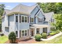 Charming two-story home with gray siding, large windows, and covered front entrance at 738 Kemp Rd, Mooresville, NC 28117