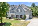 Charming two-story home with gray siding, brown shutters, and a well-manicured front yard at 738 Kemp Rd, Mooresville, NC 28117