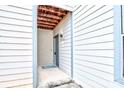 Home's entrance features a covered porch with modern lighting and a stylish gray front door at 8115 Tremaine Ct, Charlotte, NC 28227