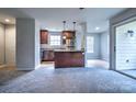 Bright kitchen with stainless steel appliances, granite countertops, and a kitchen island at 8115 Tremaine Ct, Charlotte, NC 28227