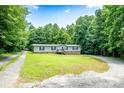 Charming single-story home with a covered front porch and a well-maintained lawn surrounded by mature trees at 812 Acclaim Dr, York, SC 29745