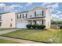 Two-story home with neutral siding, black shutters, an attached two-car garage, and a landscaped front yard at 9822 Bayview Pkwy, Charlotte, NC 28216