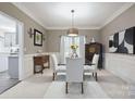 Elegant dining room with modern chandelier, neutral decor, and space for entertaining at 9954 Mitchell Glen Dr, Charlotte, NC 28277