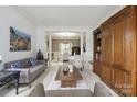 Spacious living room showcasing a custom built-in bookcase and neutral tones at 9954 Mitchell Glen Dr, Charlotte, NC 28277