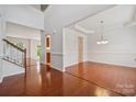 Open-concept dining room with hardwood floors, bright lighting, and staircase at 10009 Community House Rd, Charlotte, NC 28277