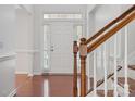 Bright entryway featuring hardwood floors, staircase, and white door with sidelights at 10009 Community House Rd, Charlotte, NC 28277
