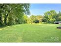 Expansive backyard with lush green grass and mature trees, perfect for outdoor activities at 114 Huffstetler Rd, Gastonia, NC 28056