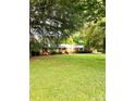 Charming brick home nestled on a lush, expansive green lawn with mature trees at 114 Huffstetler Rd, Gastonia, NC 28056