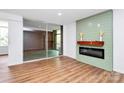 Living room featuring a modern fireplace with shiplap accent, hardwood floors and sliding glass doors at 1300 Queens Rd # 405, Charlotte, NC 28207